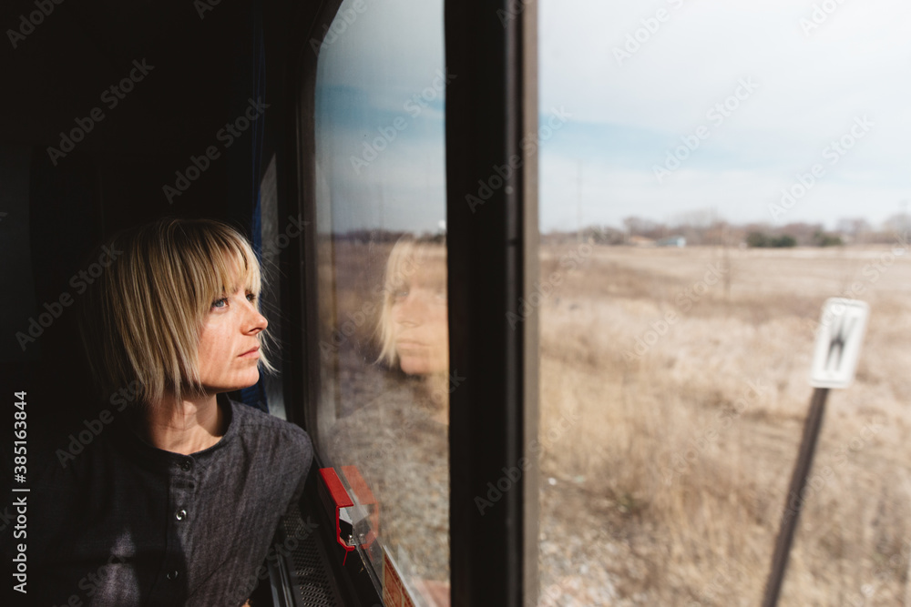 Young Woman Looking Out The Window Traveling On A Train Young Woman Looking Out The Window Traveling On A Train