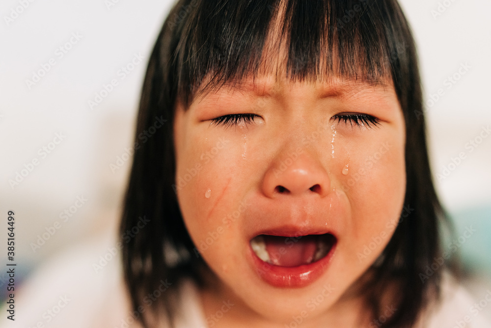 Asian little girl crying with tears in her face Asian little girl crying with tears in her face