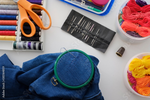 Darning a hole in a pair of blue jeans