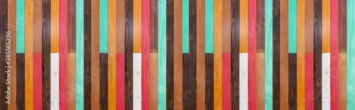 Panorama of Vintage multi-colored wooden wall pattern and seamless background