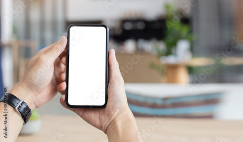 cell phone mockup blank white screen.woman hand holding texting using mobile on desk at coffee shop.background empty space for advertise.work people contact marketing business,technology