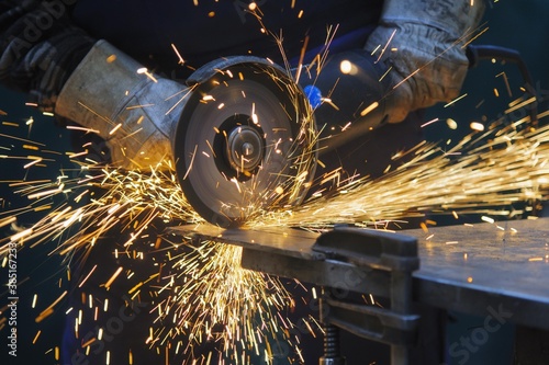 Cutting a steel plate with an angle grinder photo
