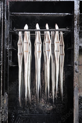 Fresh eel (Anguilla anguilla) hung in the smokehouse, Ruegen island, Mecklenburg-Western Pomerania, Germany, Europe photo