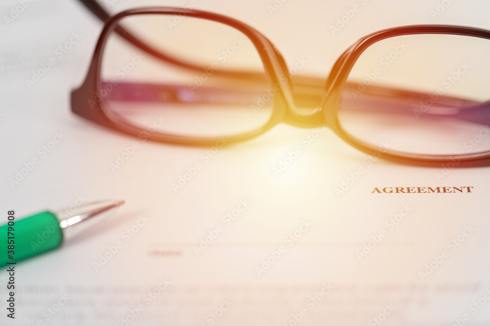 Sign on contract document with fountain pen and glasses Sign on contract document with fountain pen and glasses
