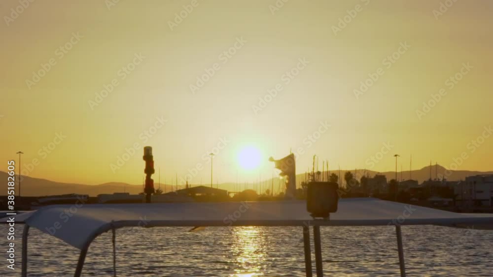 Sunset at Kalamata, summer of 2020. Small worn greek flag on a boat, waving in the foreground, 120fps Sunset at Kalamata, summer of 2020. Small worn greek flag on a boat, waving in the foreground, 120fps