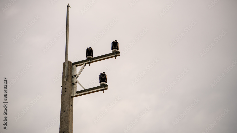 Electronic equipments on power pole, concrete power pole. Cloundy sky background. Electronic equipments on power pole, concrete power pole. Cloundy sky background.
