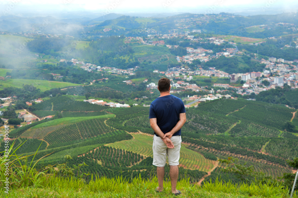 man in field looking to serra negra