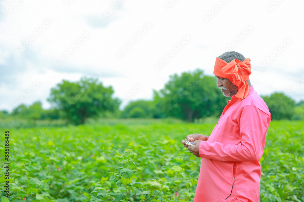 Excited farmer holding Indian rupee notes Excited farmer holding Indian rupee notes