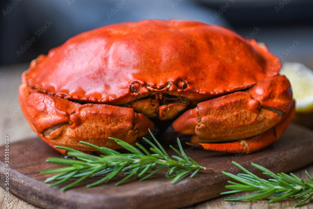Seafood shellfish Steamed red crab or Boiled stone crab - Fresh crab with ingredients lemon rosemary on wooden board Seafood shellfish Steamed red crab or Boiled stone crab - Fresh crab with ingredients lemon rosemary on wooden board