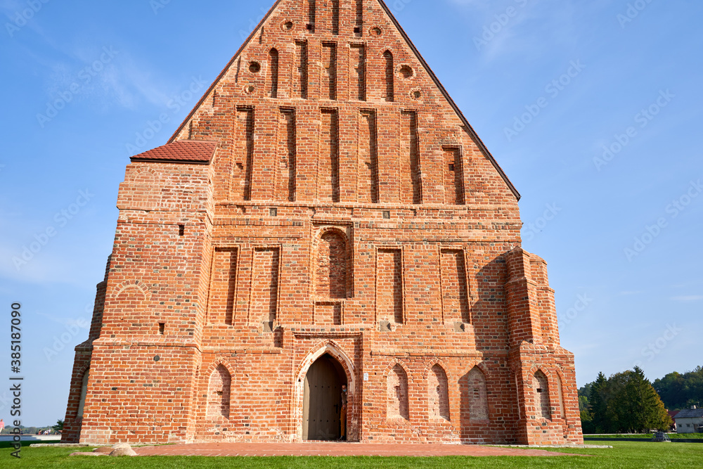 Medieval times red brick church in Zapyskis surrounded by fields 