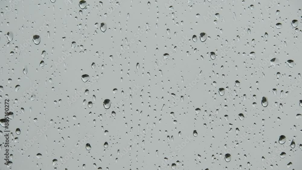 Rain drop in the window. real rain drops sliding on window glass .Streams of rain on the glass Rain drop in the window. real rain drops sliding on window glass .Streams of rain on the glass