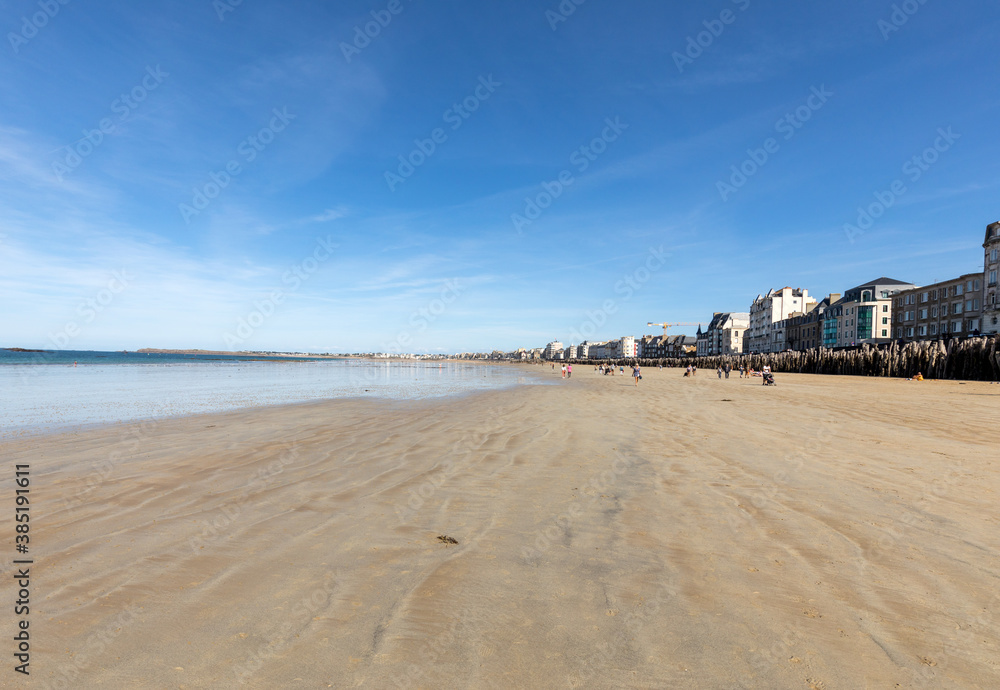Romantic walk of people before sunset on the picturesque beach of Saint Malo. Brittany, France Romantic walk of people before sunset on the picturesque beach of Saint Malo. Brittany, France