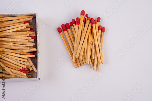 Red head matches in a white opened box on white background