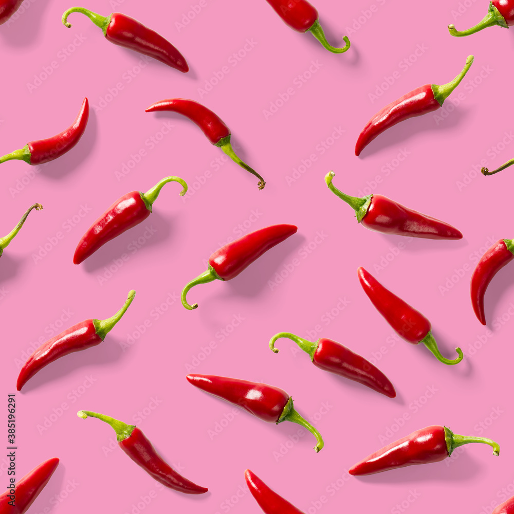 Seamless pattern made of red chili or chilli on pink background. Minimal food pattern. Red hot chilli seamless peppers pattern. Food background. Seamless pattern made of red chili or chilli on pink background. Minimal food pattern. Red hot chilli seamless peppers pattern. Food background.