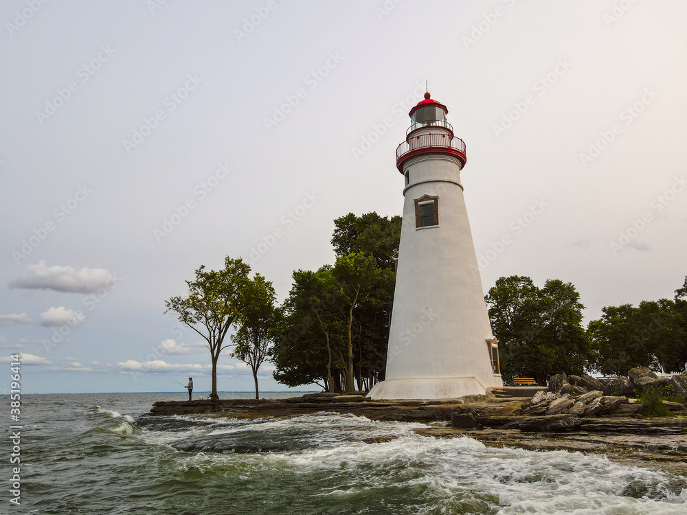 Lighthouse on the coast of Lake Erie with red roof 