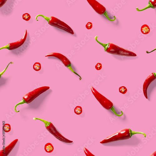 Seamless pattern made of red chili or chilli on pink background. Minimal food pattern. Red hot chilli seamless peppers pattern. Food background.