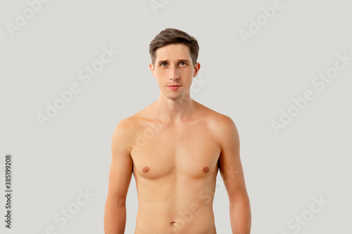 Handsome shirtless man. Healthy lifestyle. Male body care. Hygiene grooming. Attractive athletic guy looking at camera isolated on white copy space background.