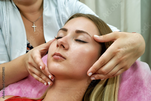 Young woman on cosmetic procedures in the spa salon