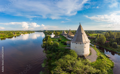 Aerial panoramic view of famous medieval fortress in Staraya Ladoga at sunset. Ancient Russian historical fort on Volkhov River on a sunny summer day. Europe  Russia  Leningrad region  St. Petersburg.