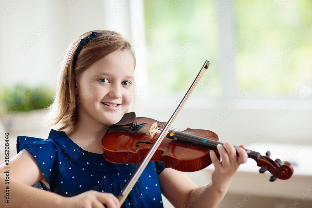 Child playing violin. Remote learning. Child playing violin. Remote learning.