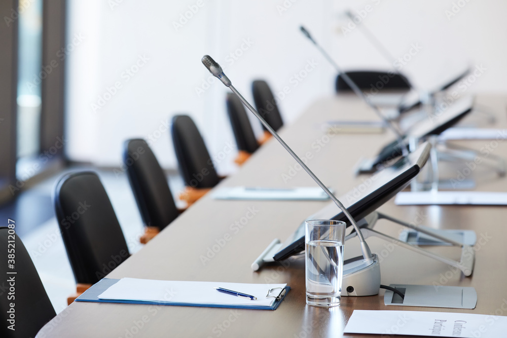 Naklejka premium Image of empty table with documents and microphones at board room