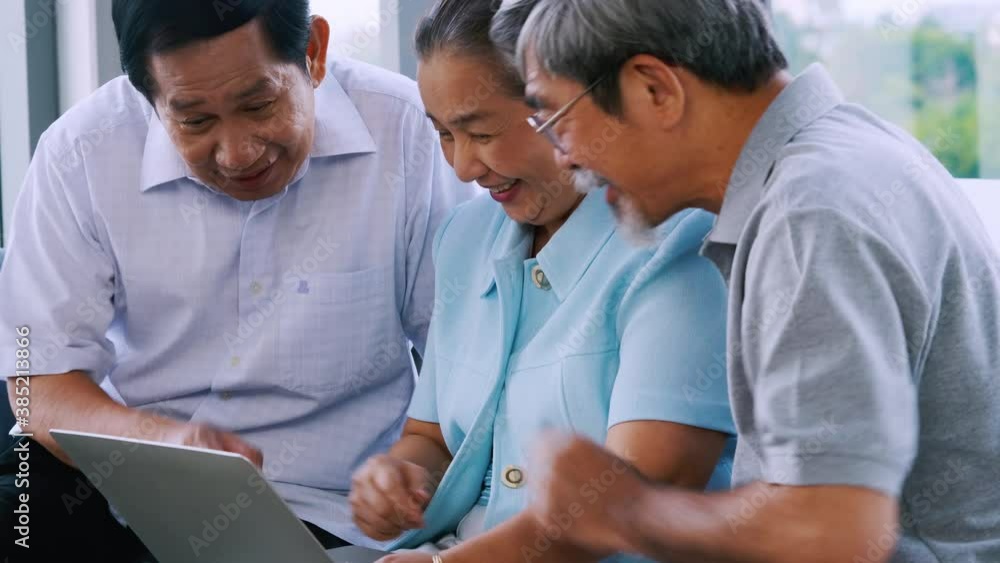 Group of senior friends using laptop together in a retirement home. Group of senior friends using laptop together in a retirement home.