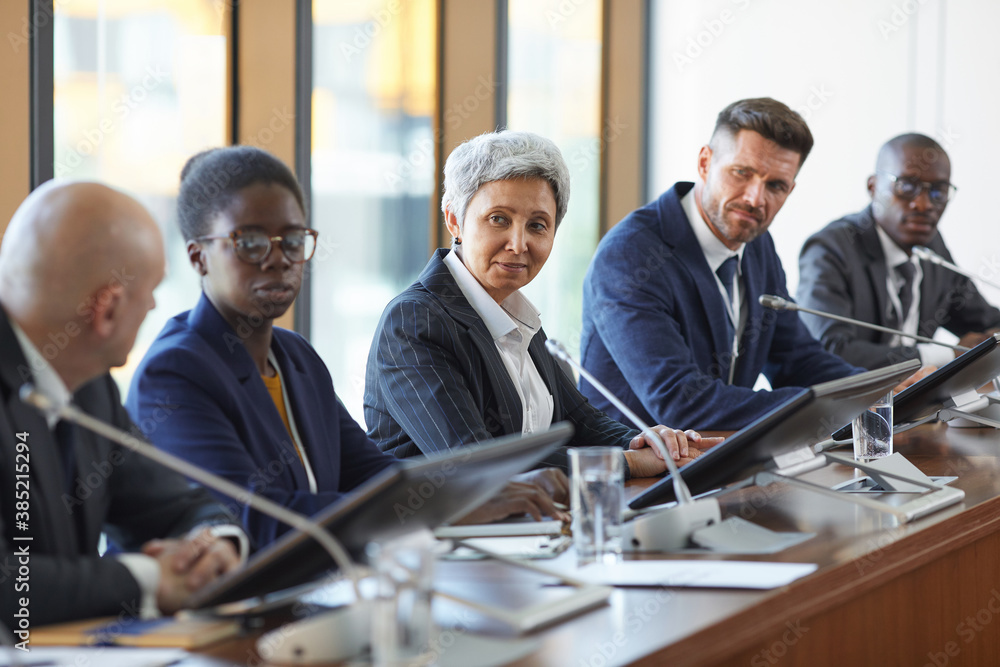 Group of business people discussing new project together in team during meeting at board room Group of business people discussing new project together in team during meeting at board room