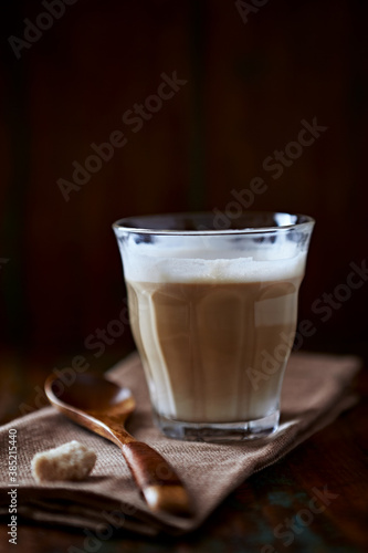 Coffee with milk on dark wooden background. Close up.
