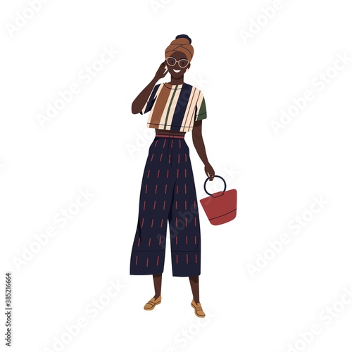 Young stylish african american woman in fashionable summer outfit. Female character demonstrating fashion clothes. Cheerful woman wearing turban. Flat vector cartoon illustration isolated on white