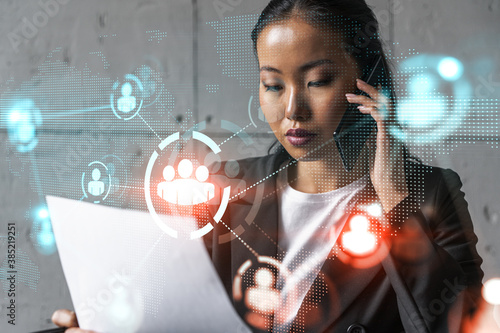 Businesswoman speaks phone and social network hologram. Double exposure.