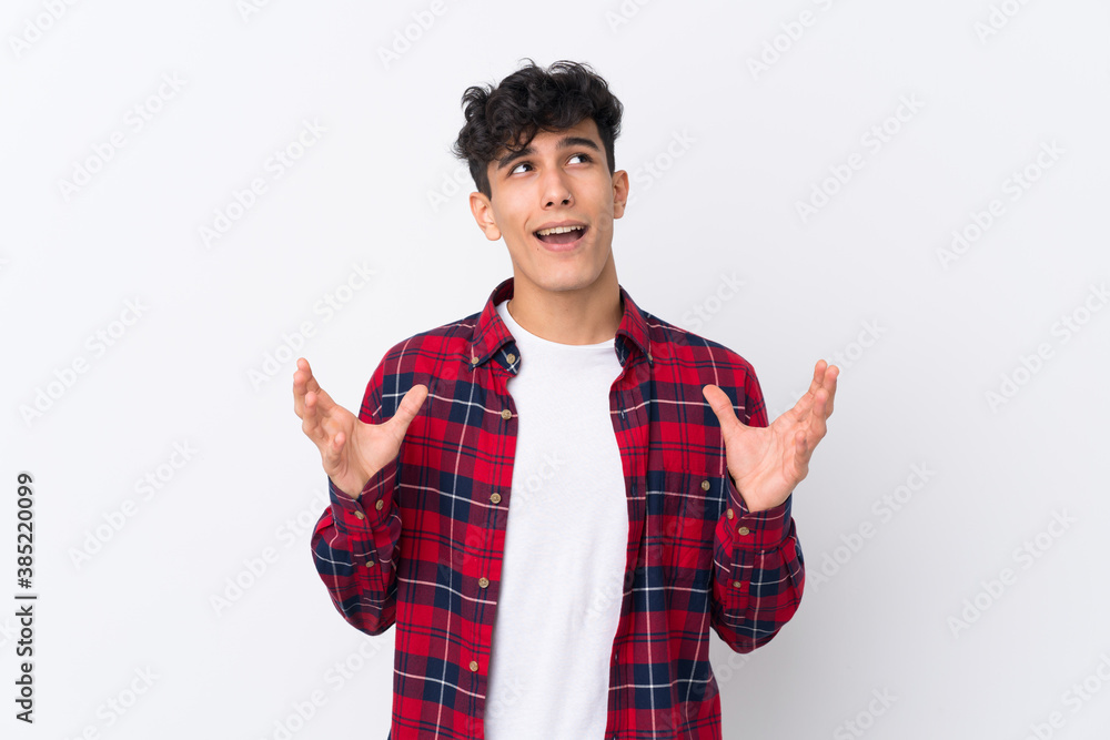 Young Argentinian man over isolated white background frustrated by a bad situation Young Argentinian man over isolated white background frustrated by a bad situation