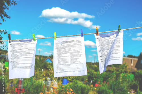 The documents tax forms were washed and dried in the open air by hanging from a clothesline. Concepts of money laundering, legalization of income, concealment of income, tax evasion photo