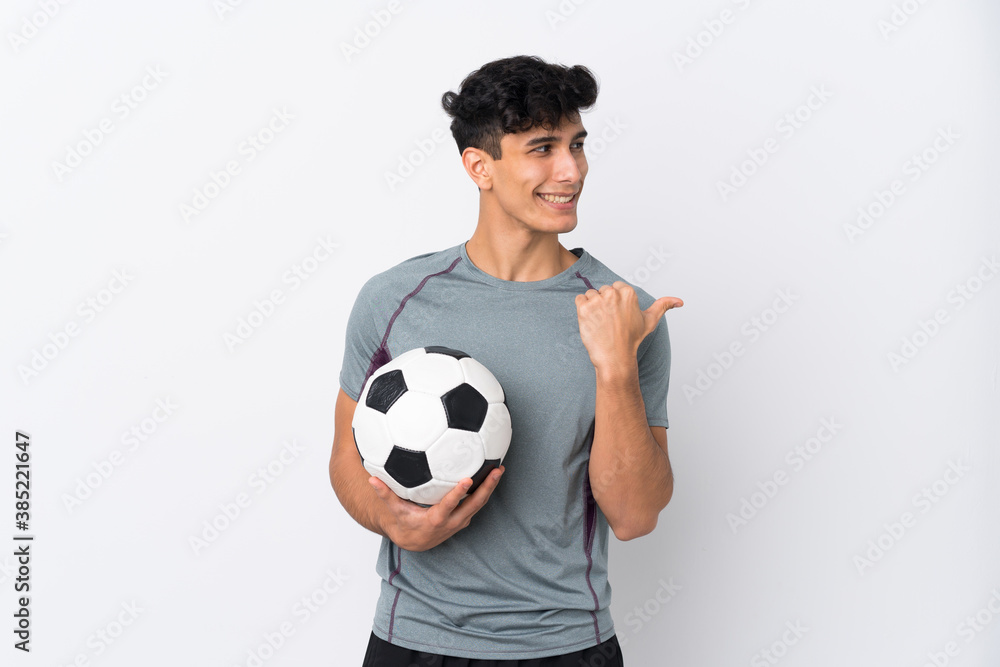 Argentinian football player man over isolated white background pointing to the side to present a product