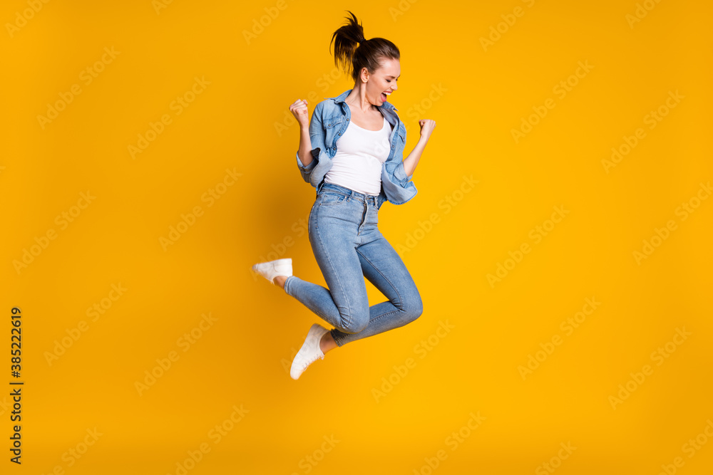 Full length body size view of her she attractive lovely slim fit glad cheerful cheery girl jumping rejoicing having fun attainment isolated bright vivid shine vibrant yellow color background