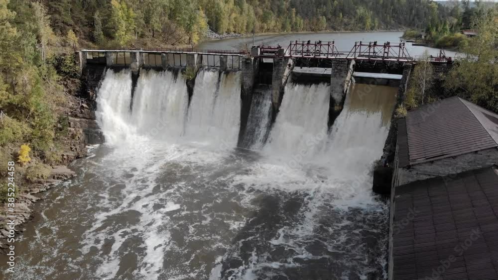 Dam on the river - water falls from a high dam Dam on the river - water falls from a high dam