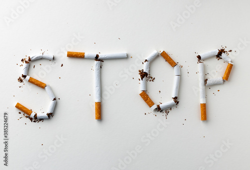 Inscription word STOP made out of cigarettes top view