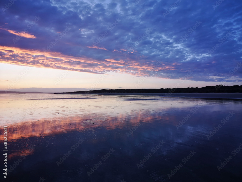 Dramatic sunset on Cefn Sidan beach with Cirrostratus clouds - is a long sandy beach, its dunes form the outer edge of the Pembrey Burrows between Burry Port and Kidwelly.