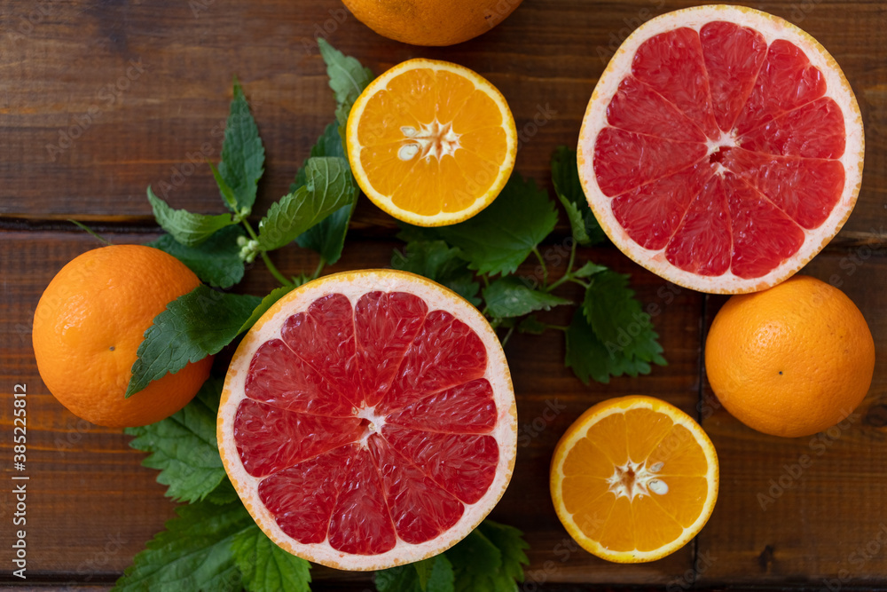 oranges and grapefruit on a brown wooden background, top view, text space, citrus oranges and grapefruit on a brown wooden background, top view, text space, citrus