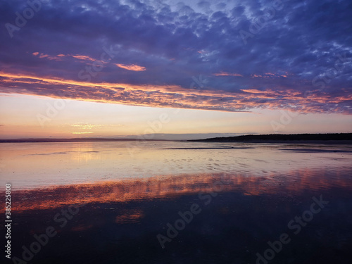 Dramatic sunset on Cefn Sidan beach with Cirrostratus clouds - is a long sandy beach  its dunes form the outer edge of the Pembrey Burrows between Burry Port and Kidwelly.