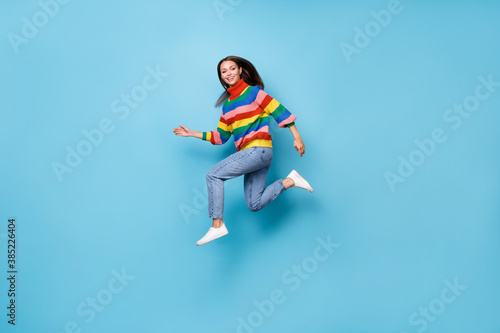 Full length body size profile side view of her she nice attractive pretty lovely cheerful cheery girl jumping running fast speed marathon isolated blue pastel color background