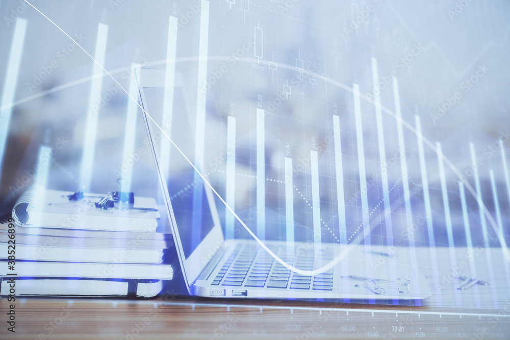 Forex graph hologram on table with computer background. Multi exposure. Concept of financial markets.