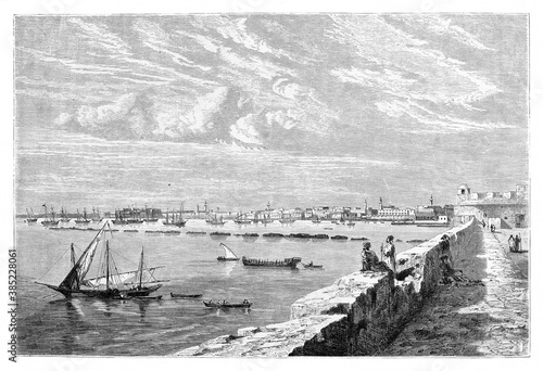 wide view of Tripoli placed in the horizon from the port view, Libya. Ancient grey tone etching style art by Berard, published on Le Tour du Monde, Paris, 1861 photo