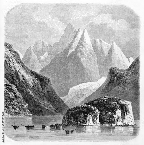 different high mountains perspective plans and rock on water foreground in the Land of Fire, Chile. Ancient grey tone etching style art by De B�rard, Le Tour du Monde, Paris, 1861 photo