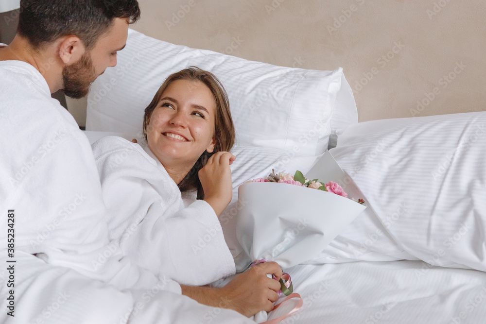 Fototapeta premium Guy gives a girl a bouquet of flowers