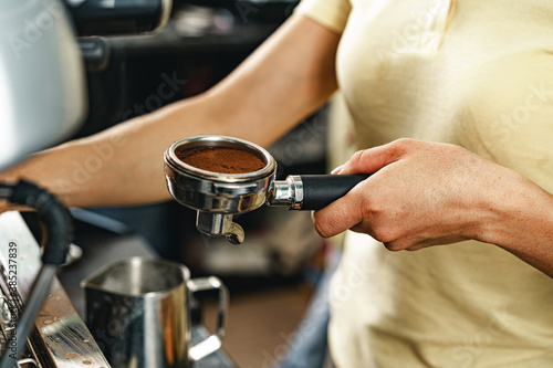 Woman coffee shop worker preparing coffee on professional coffee machine © fotofabrika