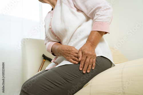 Hip pain of senior woman at home, healthcare problem of senior concept