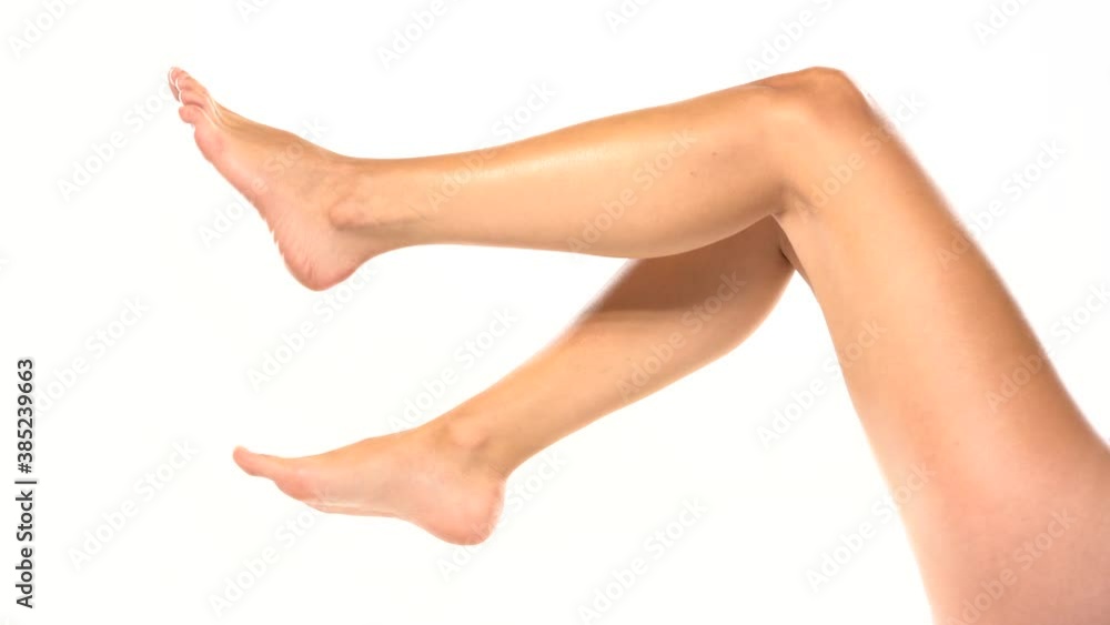 nicely groomed female legs moving on a white background nicely groomed female legs moving on a white background
