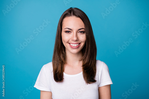 Closeup photo of attractive pretty lady good mood smiling teeth beaming charming cute straight hairstyle wear casual white t-shirt isolated blue color background © deagreez