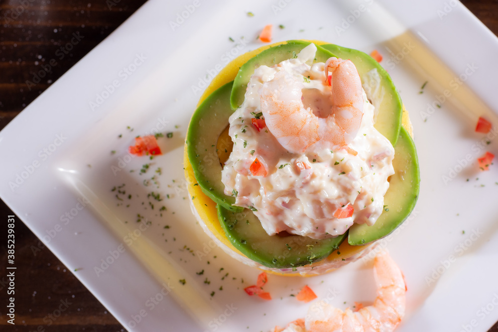 Causa with seafood prawns typical peruvian food in wood table Causa with seafood prawns typical peruvian food in wood table