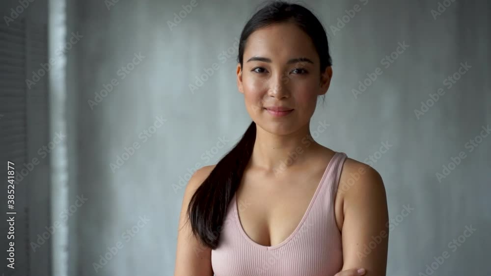 Pretty asian young woman smiling and looking to camera, broadcasting in streaming, doing online video call. Cheerful female athlete at home. Pretty asian young woman smiling and looking to camera, broadcasting in streaming, doing online video call. Cheerful female athlete at home.
